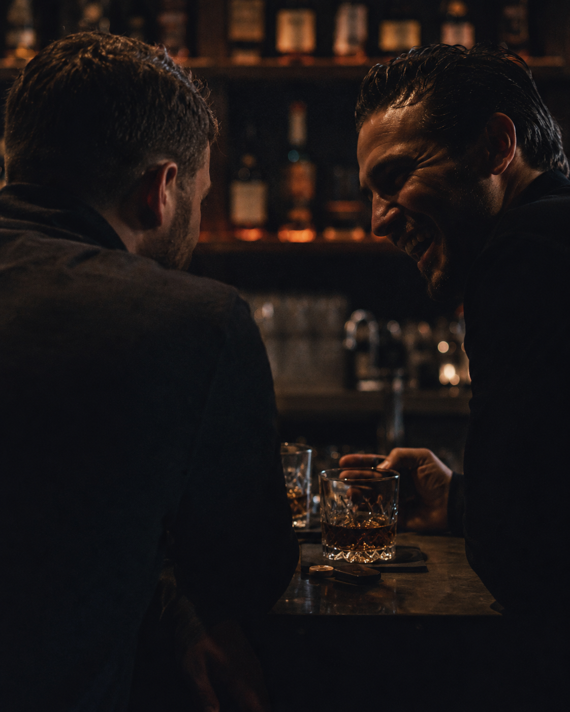 Members talking at a moody bar inside The Compound